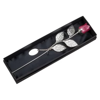 Pink rose with silver stem and plate.